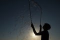 Silhouette boy playing with a bubble wand on the beach Royalty Free Stock Photo