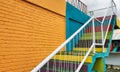 Colourful stairs to the top of building with yellow and green wall bricks Royalty Free Stock Photo