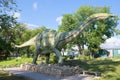 A sculpture of apatosaurus in the paleontologic park in the sunny day