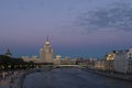 Kotelnicheskaya skyscraper just after sunset. Bolshoi Ust`insky bridge over Moscow river. Russia