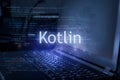 Kotlin inscription against laptop and code background. Technology concept. Learn programming language