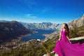 Kotor bay. Montenegro. Romantic Woman in blowing dress above Lan