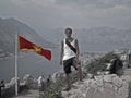 Kotor, boy and Montenegro flag.