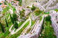 Kotor fortress walls, Montenegro with old steps and green trees Royalty Free Stock Photo