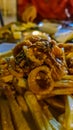 Kotor - Fried rings of squid (calamari) and french fries in luxury gourmet restaurant in the city centre of Kotor, Montenegro Royalty Free Stock Photo