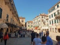 Tourists resting in restaurant while having lunch in the beautiful Old Town of  Kotor Royalty Free Stock Photo