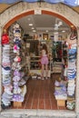 KOTOR, MONTENEGRO - JULY 18, 2021: Woman tourist in souvenir shop buying souvenir