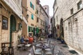 People hide in a shade of a narrow streets inside Stari Grad on