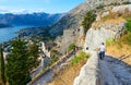 Tourists descend on steps at ancient fortress walls over Kotor, Montenegro Royalty Free Stock Photo