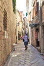 Kotor, Montenegro - 8/6/2019; Tourists walking along stone streets in Kotor, Montenegro