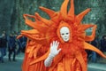 Kotor, Montenegro. February 23 2020. Winter Kotor Carnival. Lady in bright orange carnival costume and white mask