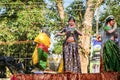 Different statues of traditional Indian women ride on open platform at religion feast