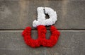 Kotwica - the emblem of the Polish resistance against German occupation, made of flowers on a concrete wall