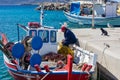 Koufonisi island, Cyclades, Greece. Moored fishing boats at dock background