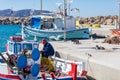 Koufonisi island, Cyclades, Greece. Moored fishing boats at dock background