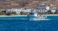 Koufonisi island, Cyclades, Greece. Sailing fishing boat, village background