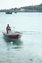 Small boat  sails into harbor at the beautiful small Greek island of Koufonisi Royalty Free Stock Photo