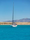 Koufonisi island, Pori beach, Cyclades, Greece. Moored yacht background. Vertical