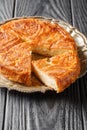 Kouign-amann is a sweet Breton cake made with laminated dough closeup on the plate. Vertical