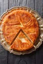 Kouign-amann is a sweet Breton cake made with laminated dough closeup on the plate. Vertical top view