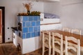 Kourim, Bohemia, Czech Republic, 26 December 2021: Interior of Traditional village house, blue ceramic tiled stove, table and