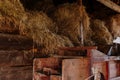 Kourim, Czech Republic, 17 December 2023: Inside rustic wooden old barn hay, Attic of hayloft, Bales dry straw, light beams farm, Royalty Free Stock Photo