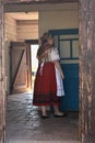 Woman in traditional costume in the corridor of a historic country house