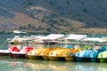 Kournas lake, Crete, Greece-October 13, 2019: colorful water catamarans near the shore of a magnificent lake in the mountains on a