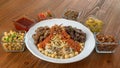 Koushari egyptian food with chicken liver and beef kebab, chickpea, noodles, boiled rice, lentil, fried onion, tomato, chili sauce Royalty Free Stock Photo