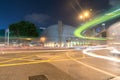 Long exposure captures light trails from passing and turning traffic in dark night urban street scene Royalty Free Stock Photo