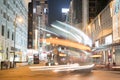 Night long exposure of passing vehicles on busy city street.