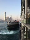 Kowloon, Hong Kong: Star Ferry leaving dock at sunset Royalty Free Stock Photo