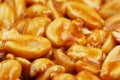 Kozinaki from golden, roasted peanuts beans as a background, texture. Macro shooting, close-up. Place for text Royalty Free Stock Photo