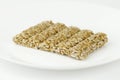 Kozinaki on a white plate, close-up. Cereal sweets