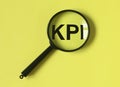 KPI acronym, word through magnifier. Key performance indicator research Royalty Free Stock Photo