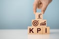 KPI - Key Performance Indicator. Businessman holds cube with KPI icon, business goals, performance results and indicators. Target Royalty Free Stock Photo