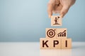 KPI - Key Performance Indicator. Businessman holds cube with KPI, KPI key performance indicator increase optimisation business. Royalty Free Stock Photo