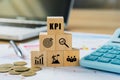 KPI, Key Performance Indicator.KPI icon on wooded cube with paperwork calculator and coin on a board room table. business goals,