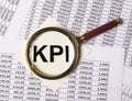 KPI through magnifying lens on documents with numbers Royalty Free Stock Photo