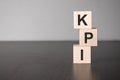 KPI wooden blocks with letters, key performance indicator KPI concept, top view on grey background Royalty Free Stock Photo