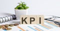 KPI word on wood blocks concept with chart, coins, notebook and glasses Royalty Free Stock Photo