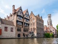 Kraanrei canal with historic buildings and belfry tower in Bruges, Belgium