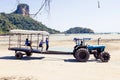 Krabi Province, Thailand - May 12, 2019: A special tractor with a passenger trailer delivers tourists and luggage to the shore