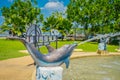 KRABI, THAILAND - FEBRUARY 19, 2018: Close up of stoned dolphing in artificial pond close to the river in Krabi town