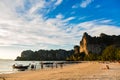 Krabi, Thailand - February 11, 2019: Sunset and wooden longtail boats on Railay beach. Tourists rest and see off the sunset