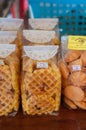Krabi, Thailand - January 23, 2019: Different kind of cookies and waffles packed in clear plastic bags standing on a shelve at a