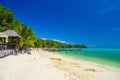 KRABI, THAILAND- MARCH 2018: Pretty women girls in bikini wimming in azure sea and long tail boats on a white sandy beach on Ko Royalty Free Stock Photo