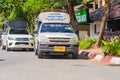 KRABI, THAILAND - 12 May 2016: Tourist shuttle public taxi parked on the public roadway along the beach in Ao Nang town