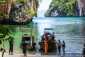 Krabi Thailand. October 2010.Tourists embark on boats on beach o