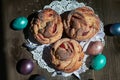 Kraffins on a white napkin and Easter eggs on a wooden background, top view Royalty Free Stock Photo